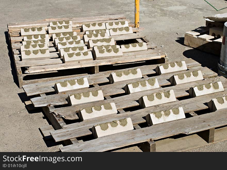 Bricks mortared together to form corners drying in the sun. Bricks mortared together to form corners drying in the sun.