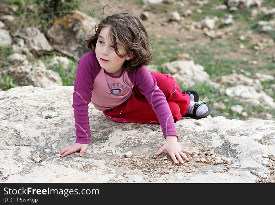 Little girl on the rock