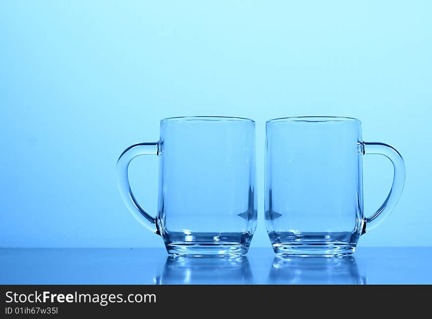 An empty glass in blue background.