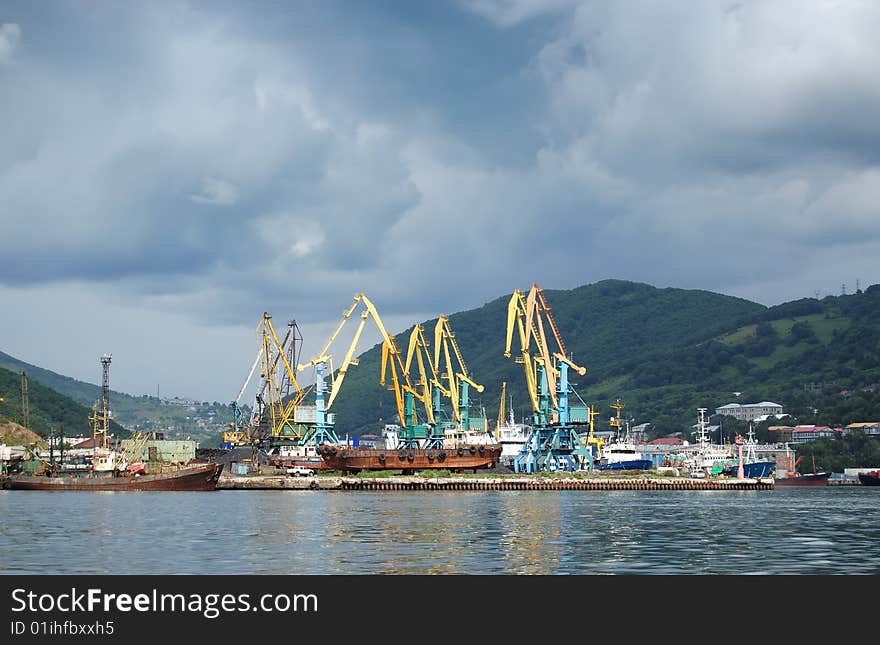 A small port with cranes and ships. A small port with cranes and ships