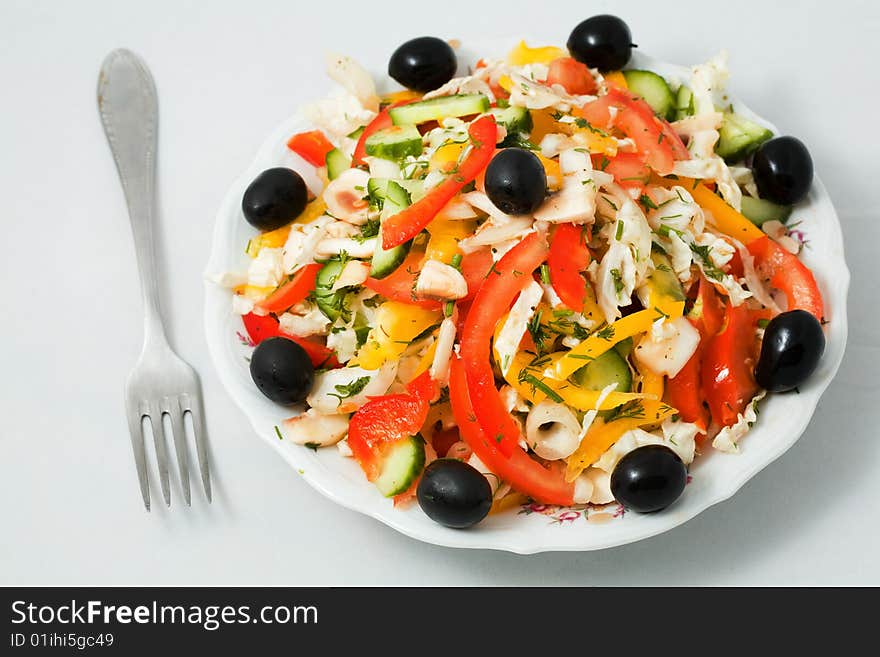 Stock photo: an image of fork and a plate of salad. Stock photo: an image of fork and a plate of salad