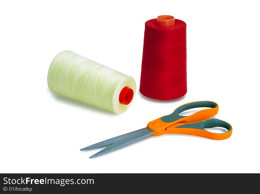 Spools and scissors against white background