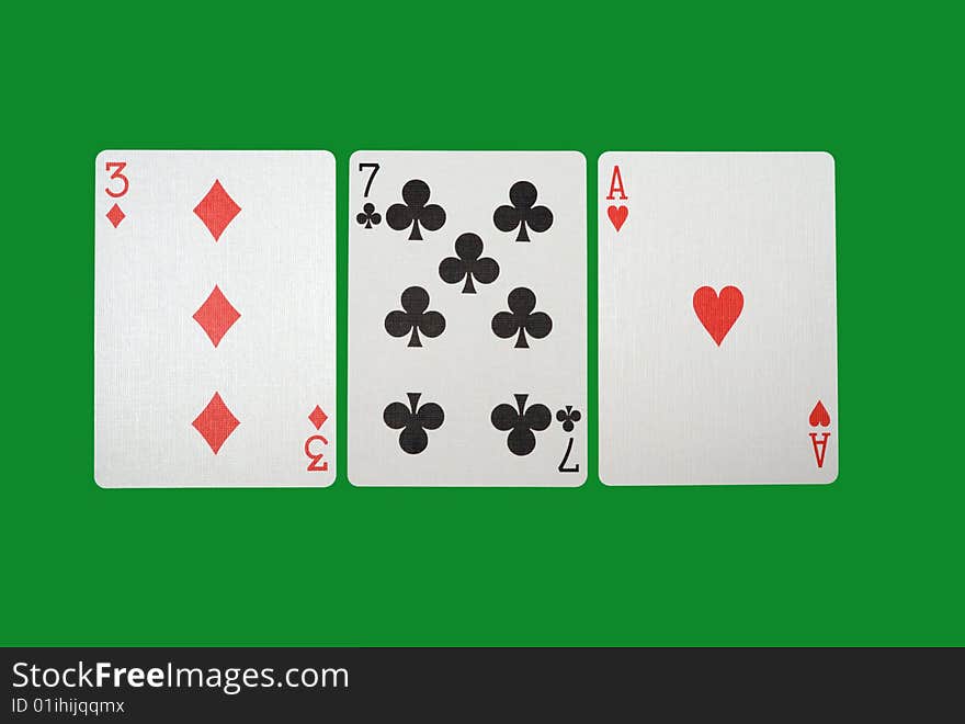 Playing cards isolated against green background