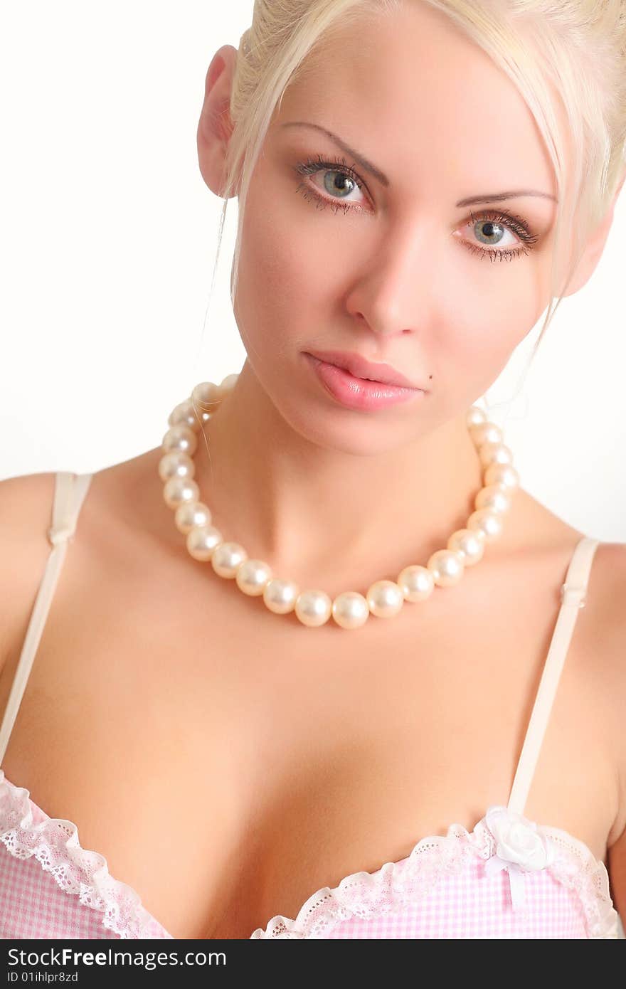 Portrait of the beautiful blonde with a pearl beads on a neck. Portrait of the beautiful blonde with a pearl beads on a neck