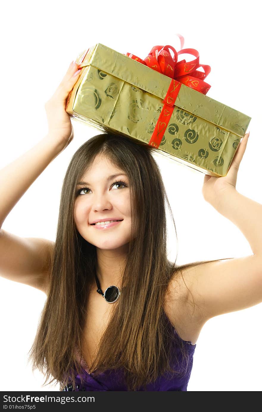 Portrait of a happy beautiful girl holding a present on her head. Portrait of a happy beautiful girl holding a present on her head