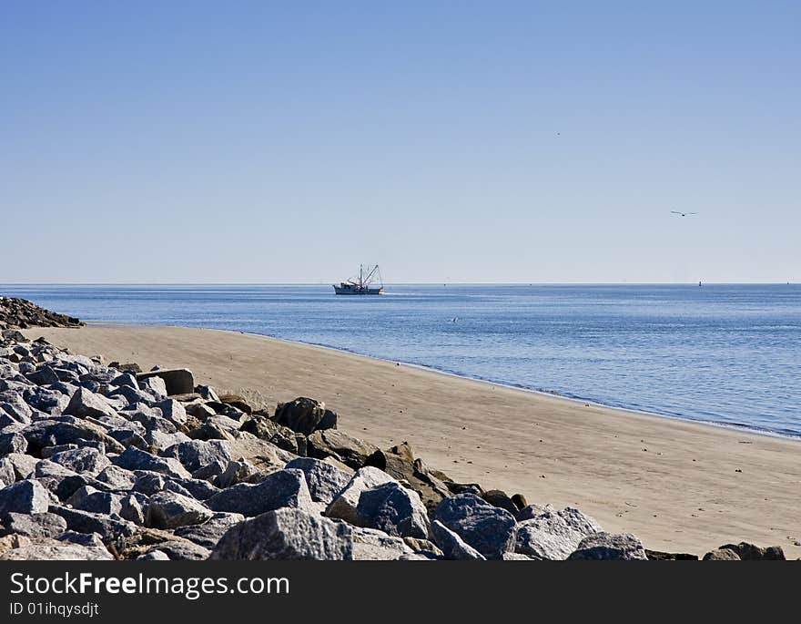 Shrimp Boat Past Rocky Beach