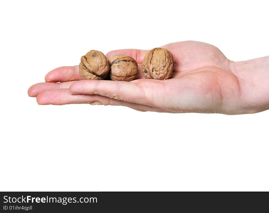 Hand holding three walnuts over white background