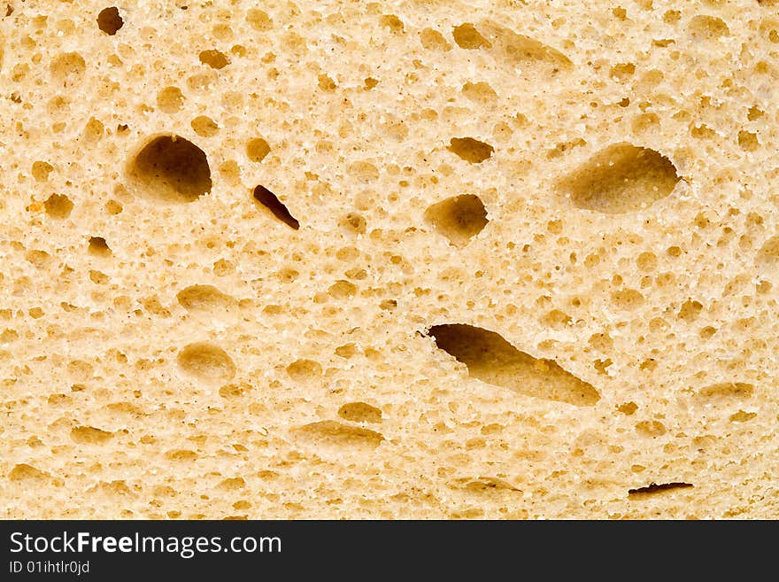 A close up of the texture of a slice of white bread. A close up of the texture of a slice of white bread