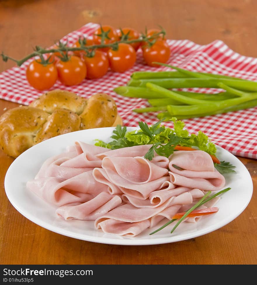 Morning meal - bread roll, ham and tomatoes. Morning meal - bread roll, ham and tomatoes