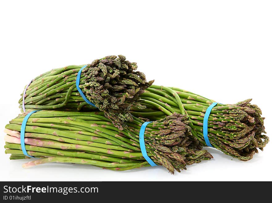 Small bundles of Mexican Asparagus over white.