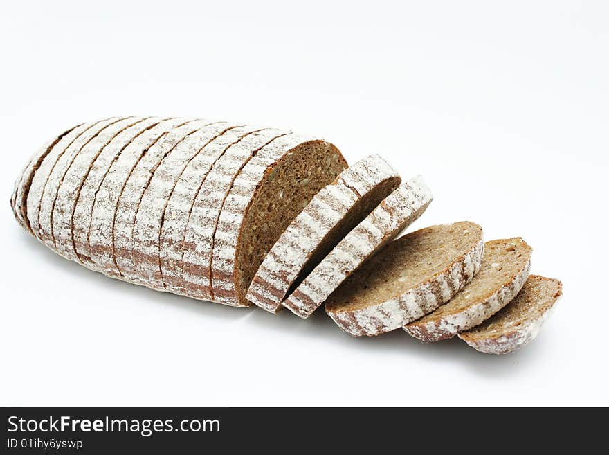 Sliced loaf of cereal bread on white background