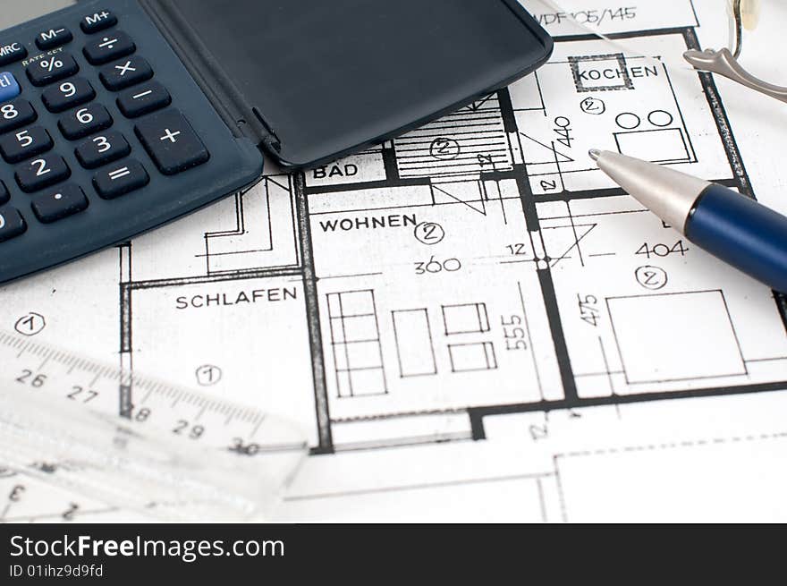 Floorplan with calculator, ruler and pen