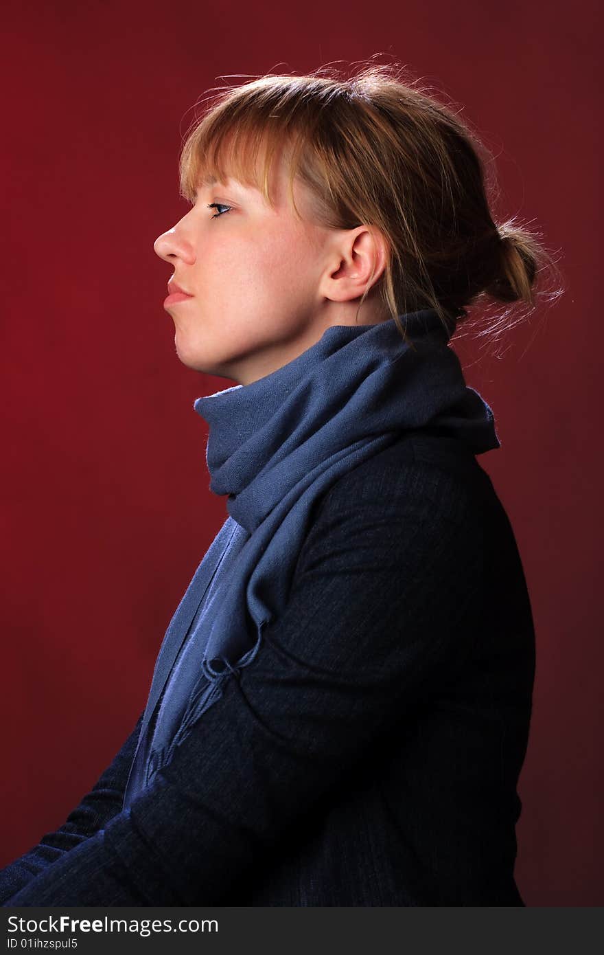 Portrait of female on a red background in studio