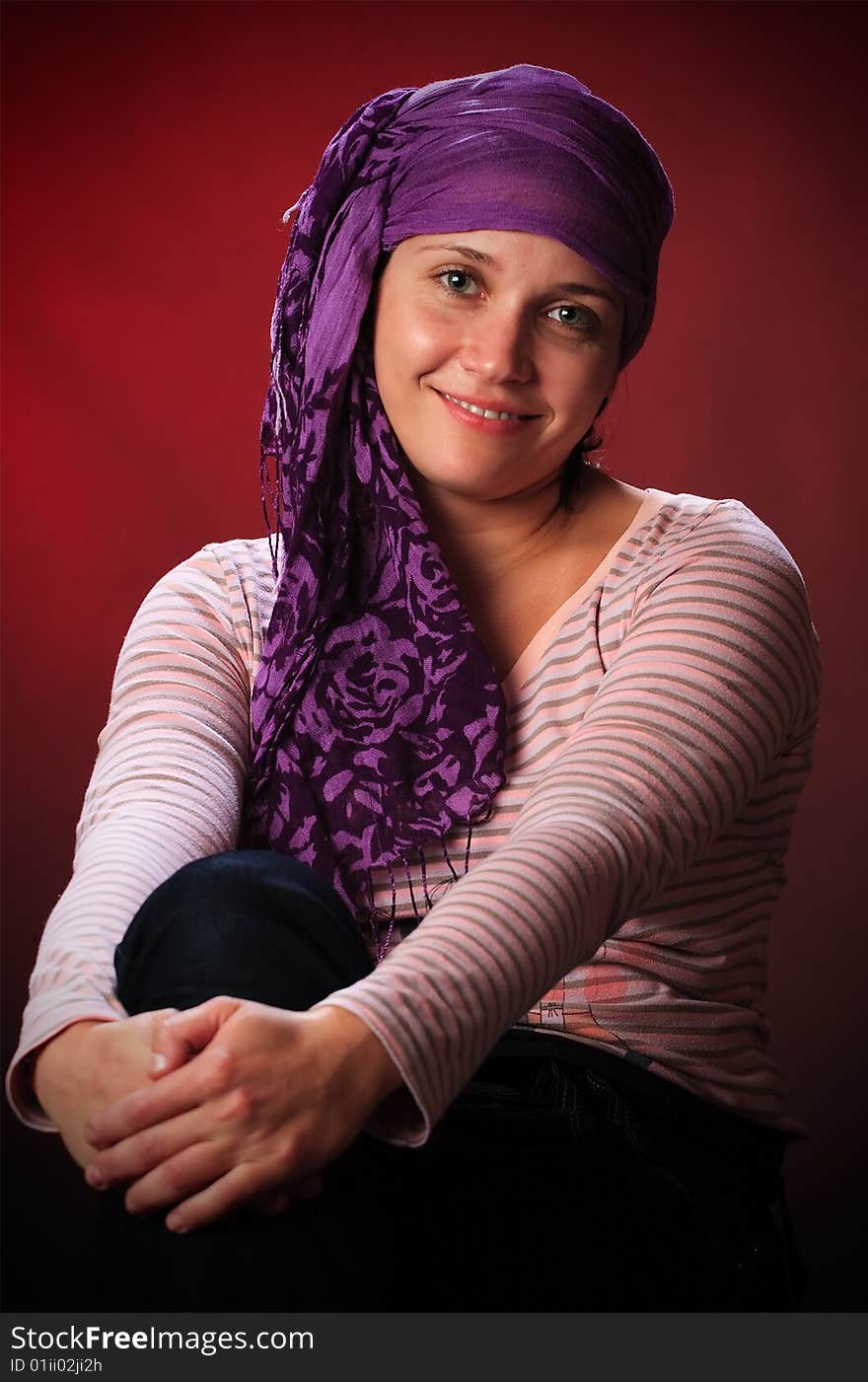 Portrait of female on a red background in studio