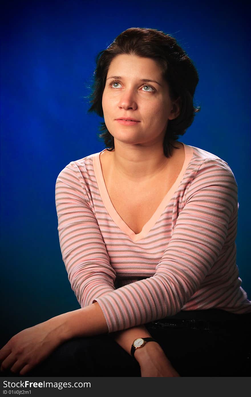 Portrait of female on a blue background in studio