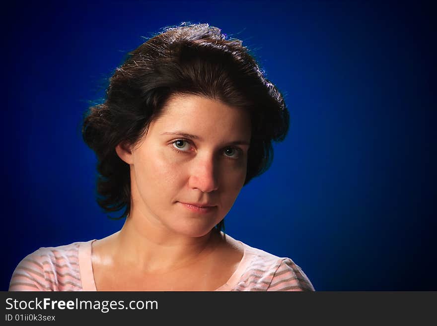 Portrait of female on a blue background in studio