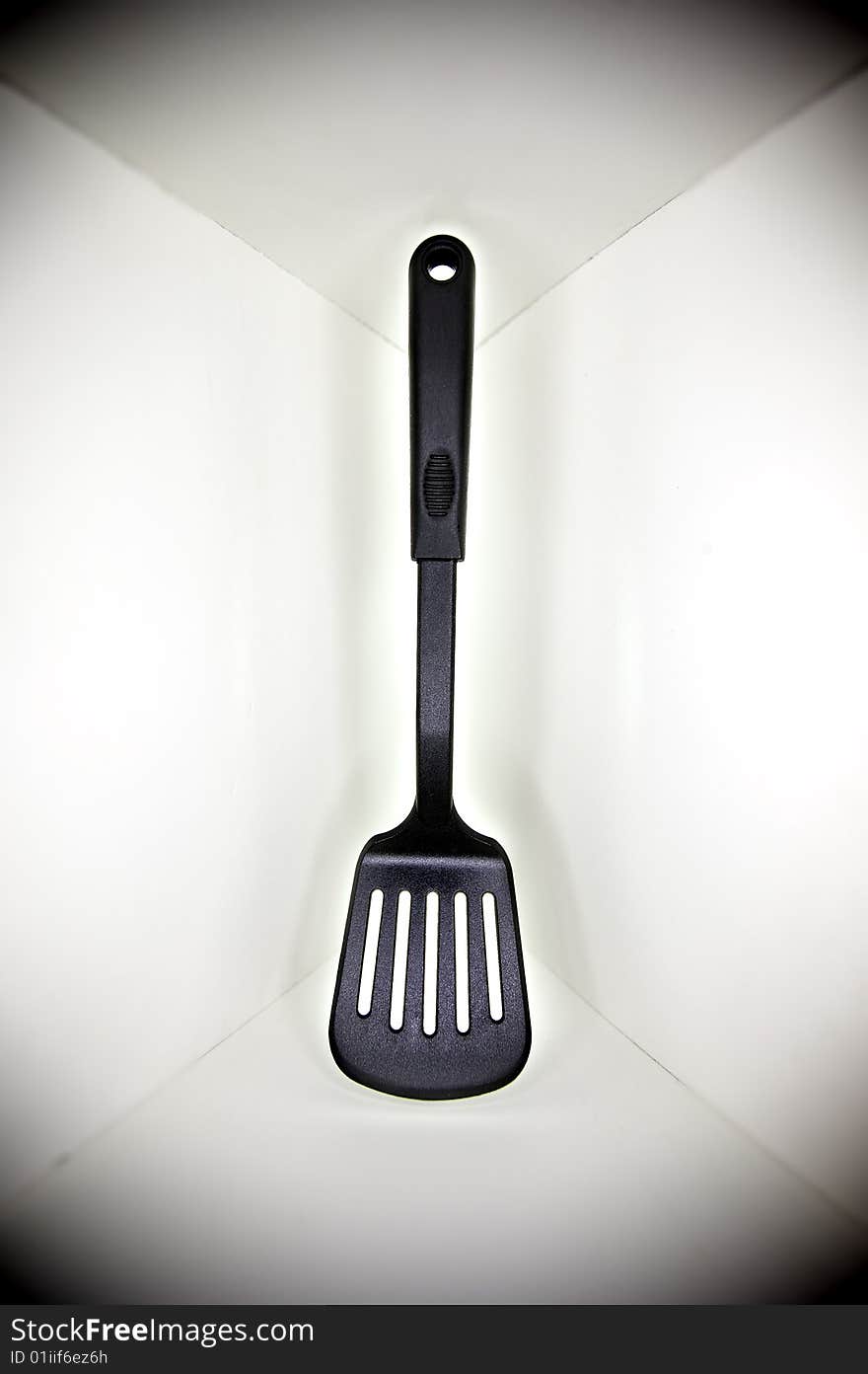 Black plastic spatula, floated in a white cornered background, with a surrounding shadow. Black plastic spatula, floated in a white cornered background, with a surrounding shadow.