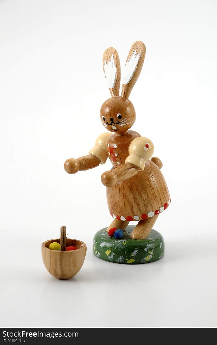 Easter rabbit with basket and easter eggs against white background