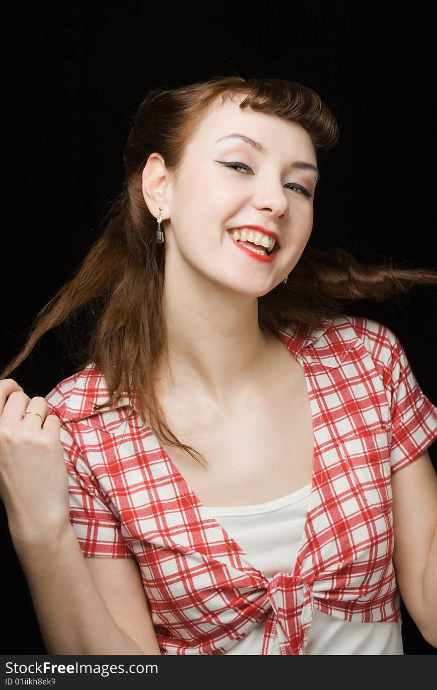 Pretty retro-style woman touching her hair, smiling and looking up over dark background. Pretty retro-style woman touching her hair, smiling and looking up over dark background