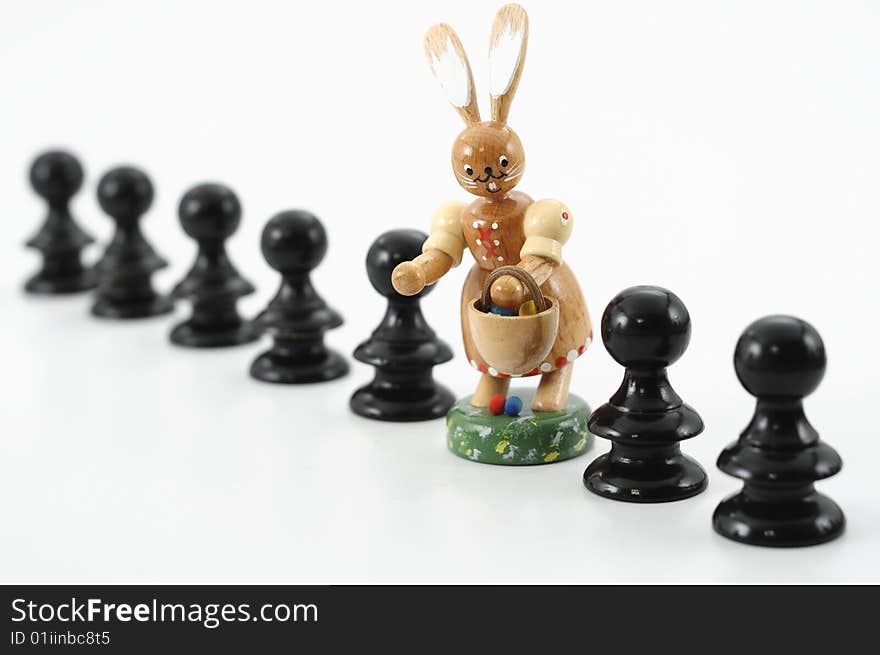 Row of pawns with easter rabbit, focus on rabbit. Row of pawns with easter rabbit, focus on rabbit