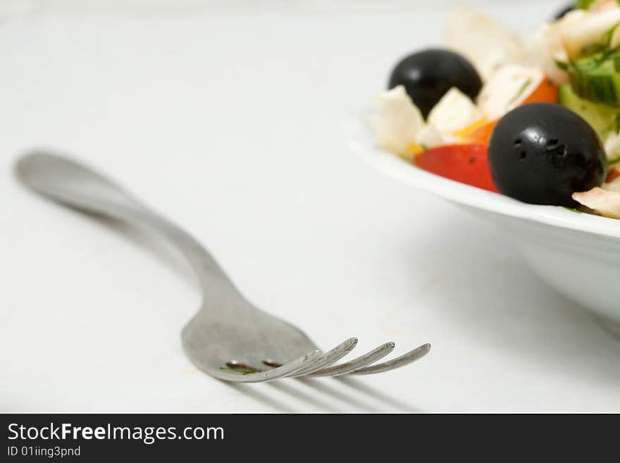 Stock photo: an image of a fork and a plate of tasty salad. Stock photo: an image of a fork and a plate of tasty salad