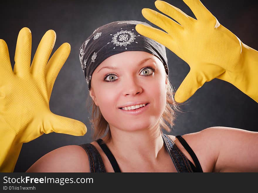 Young smiling woman with yellow rubber gloves