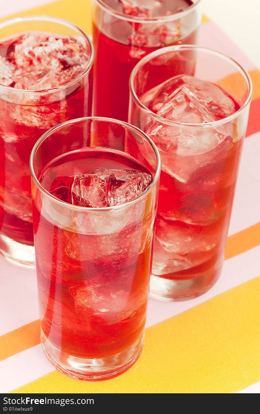 Chilled red beverage with ices on the tall glass