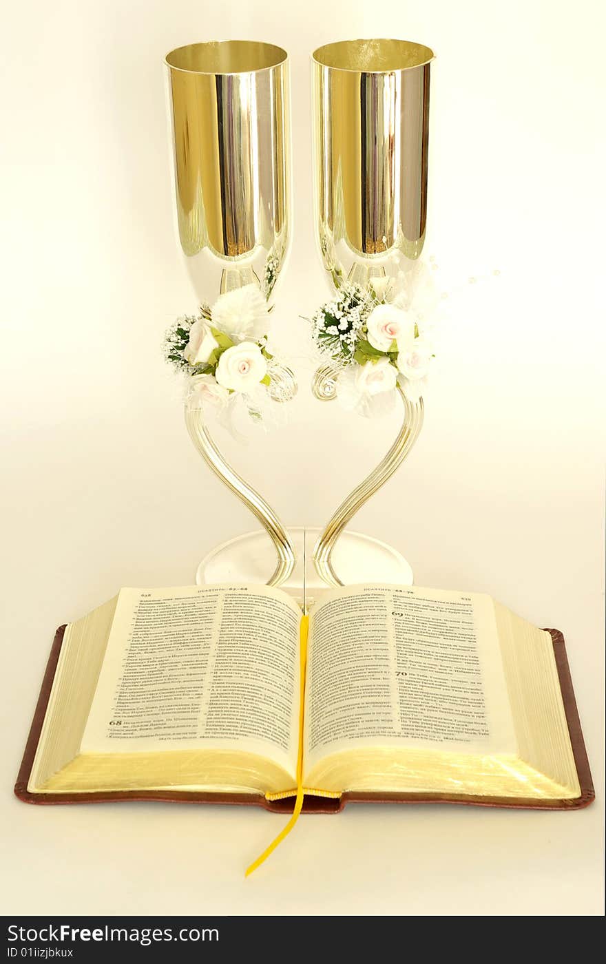 Bible with glasses on a white background