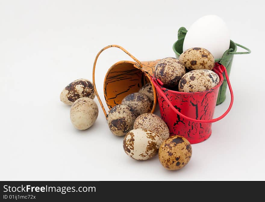 Toy buckets filled eggs on white background. Toy buckets filled eggs on white background