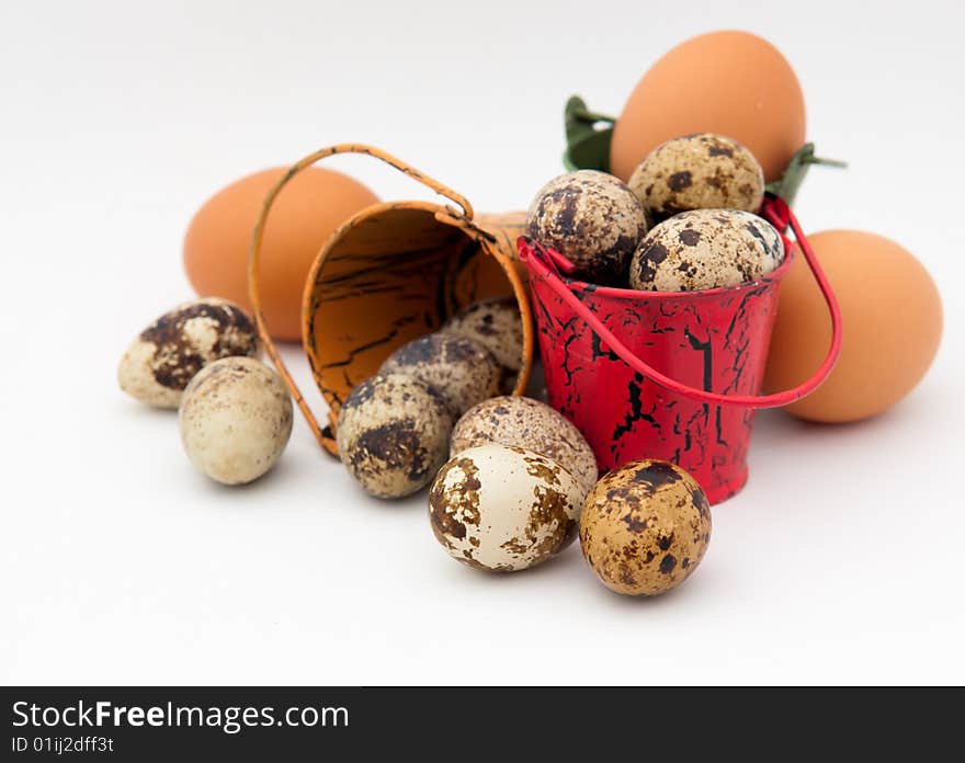 Still life of toy buckets and eggs on white background. Still life of toy buckets and eggs on white background