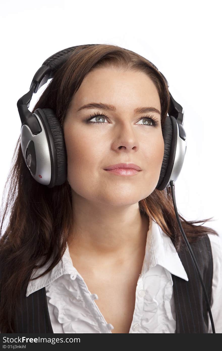 Isolated young business woman listening music over white background