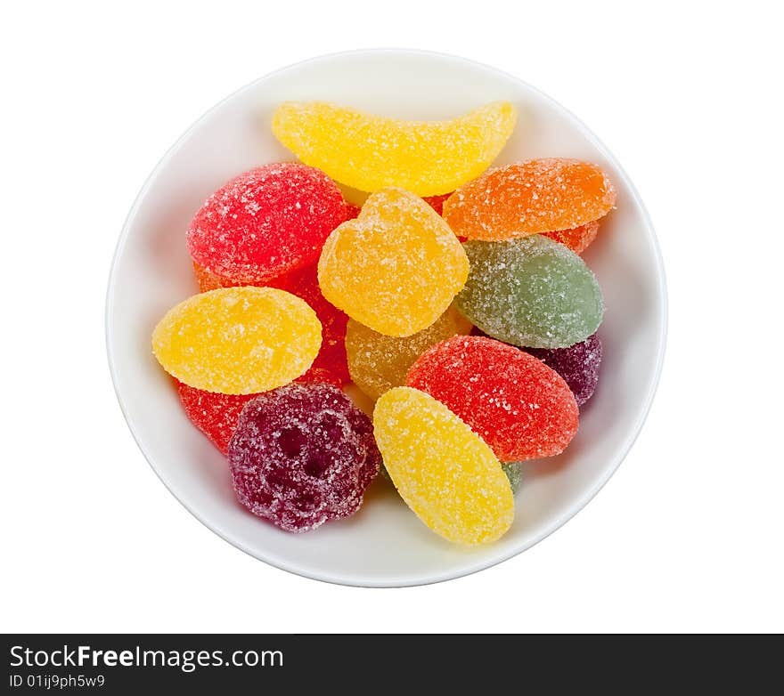 Bowl of fruit candy in many colors isolated on a white background. Bowl of fruit candy in many colors isolated on a white background