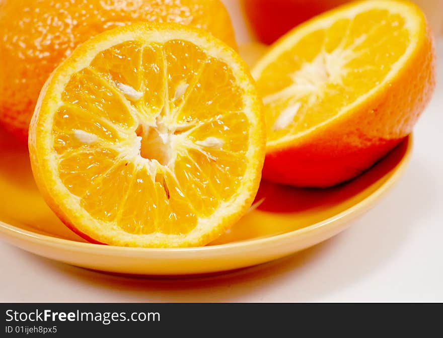 Saucer and orange isoliated on wait