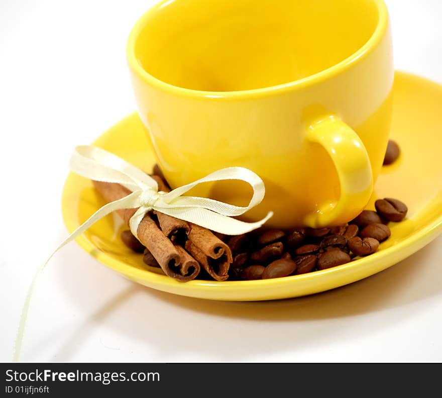 Cup, coffee grains and cinnamon