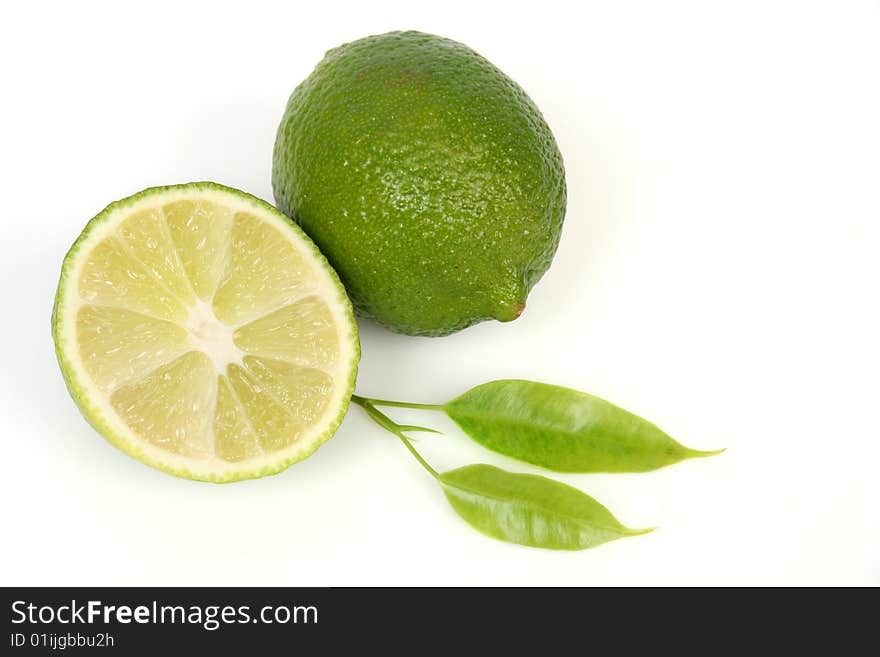 Two green lemons and leaf. Two green lemons and leaf