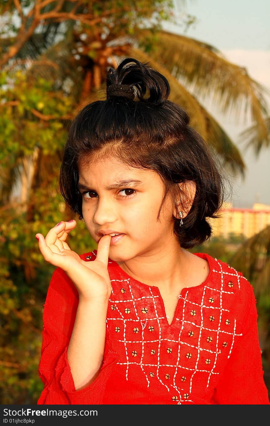 A nice and beautiful Indian girl eating something. A nice and beautiful Indian girl eating something.