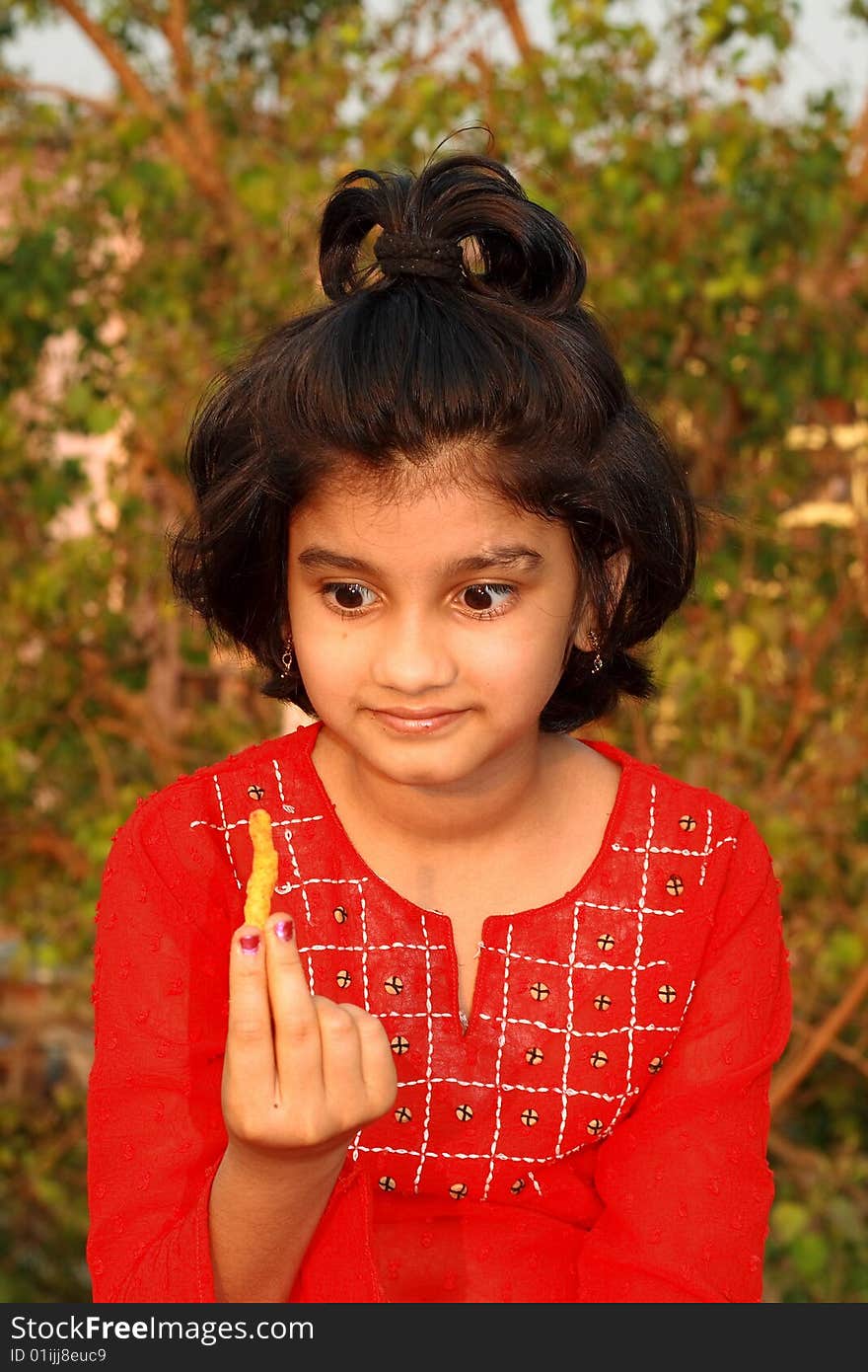 A nice and beautiful Indian girl having a yummy feeling about her snacks. A nice and beautiful Indian girl having a yummy feeling about her snacks.