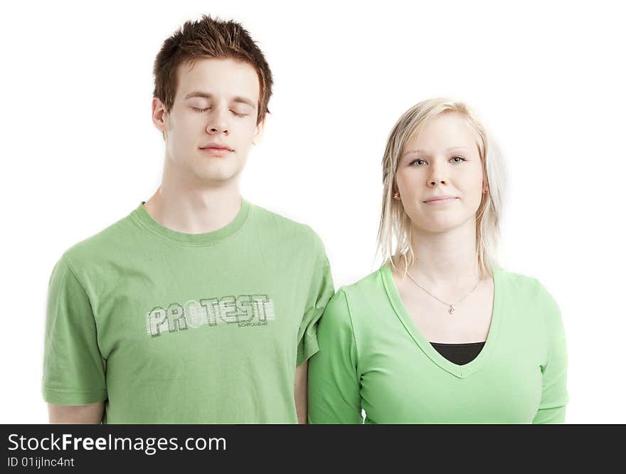 Isolated cute young couple in love over white background wearing green shirts