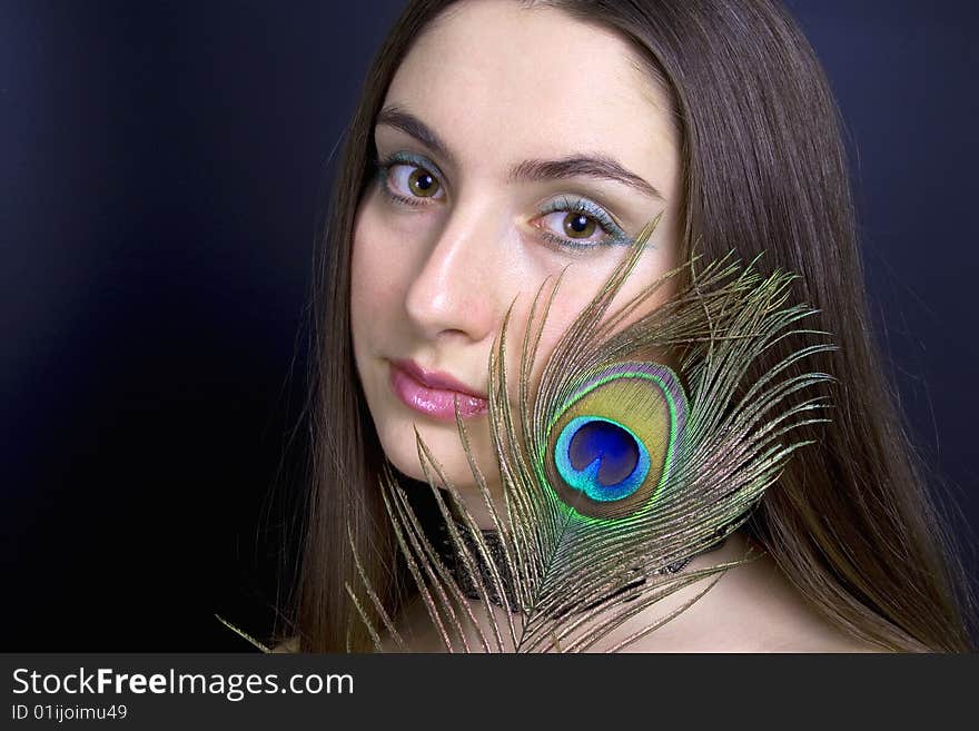 Portrait attractive woman with peacock feather, horizontal. Portrait attractive woman with peacock feather, horizontal