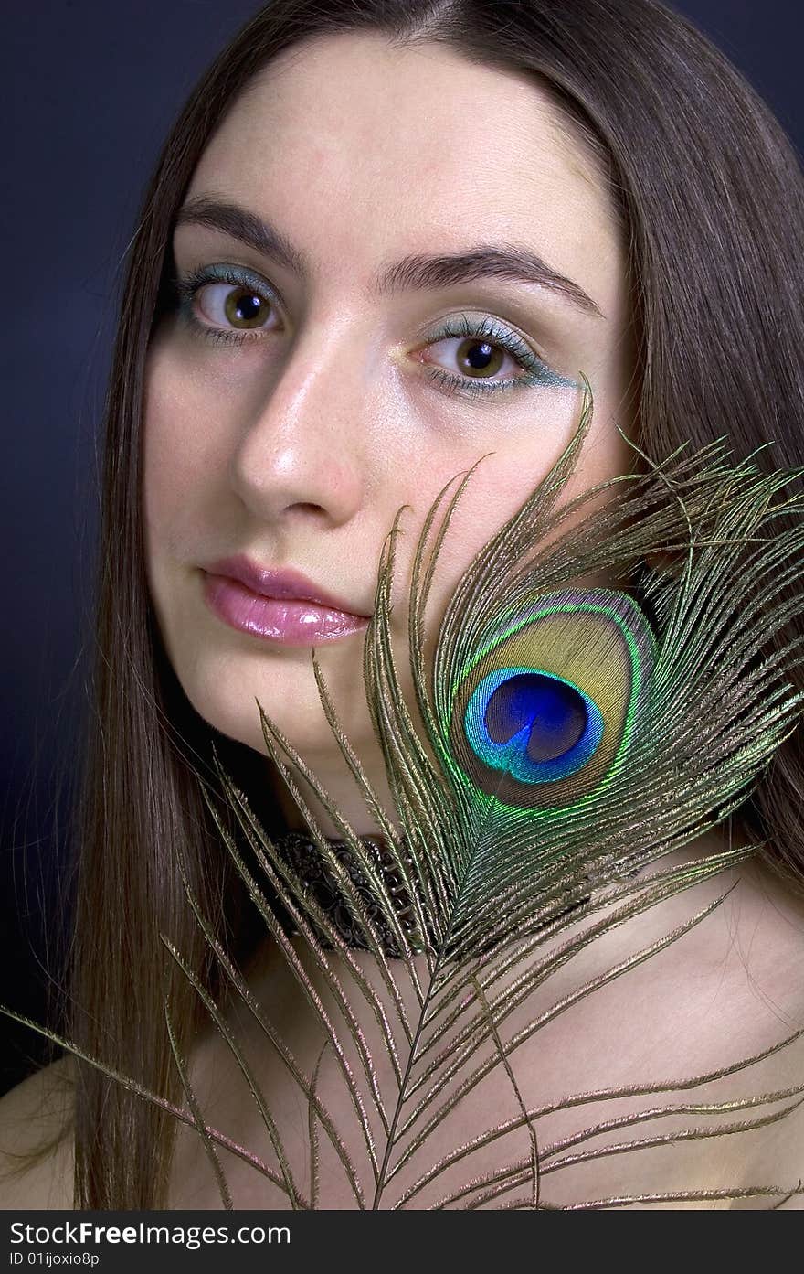 Portrait attractive woman with peacock feather, vertical. Portrait attractive woman with peacock feather, vertical