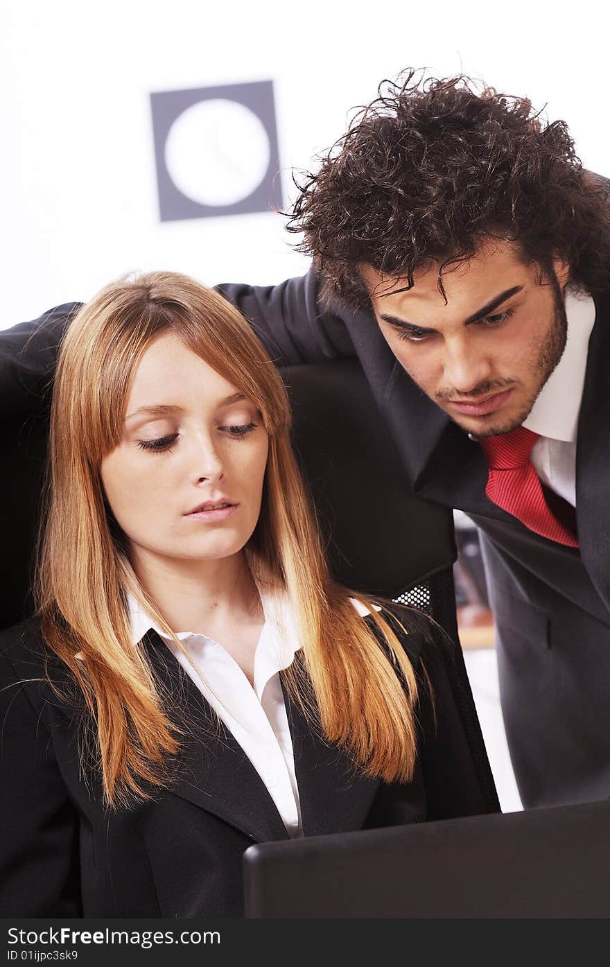 Worker couple uses laptop in the office