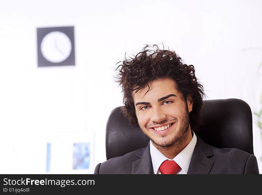 Businessman, smiling and looking in camera