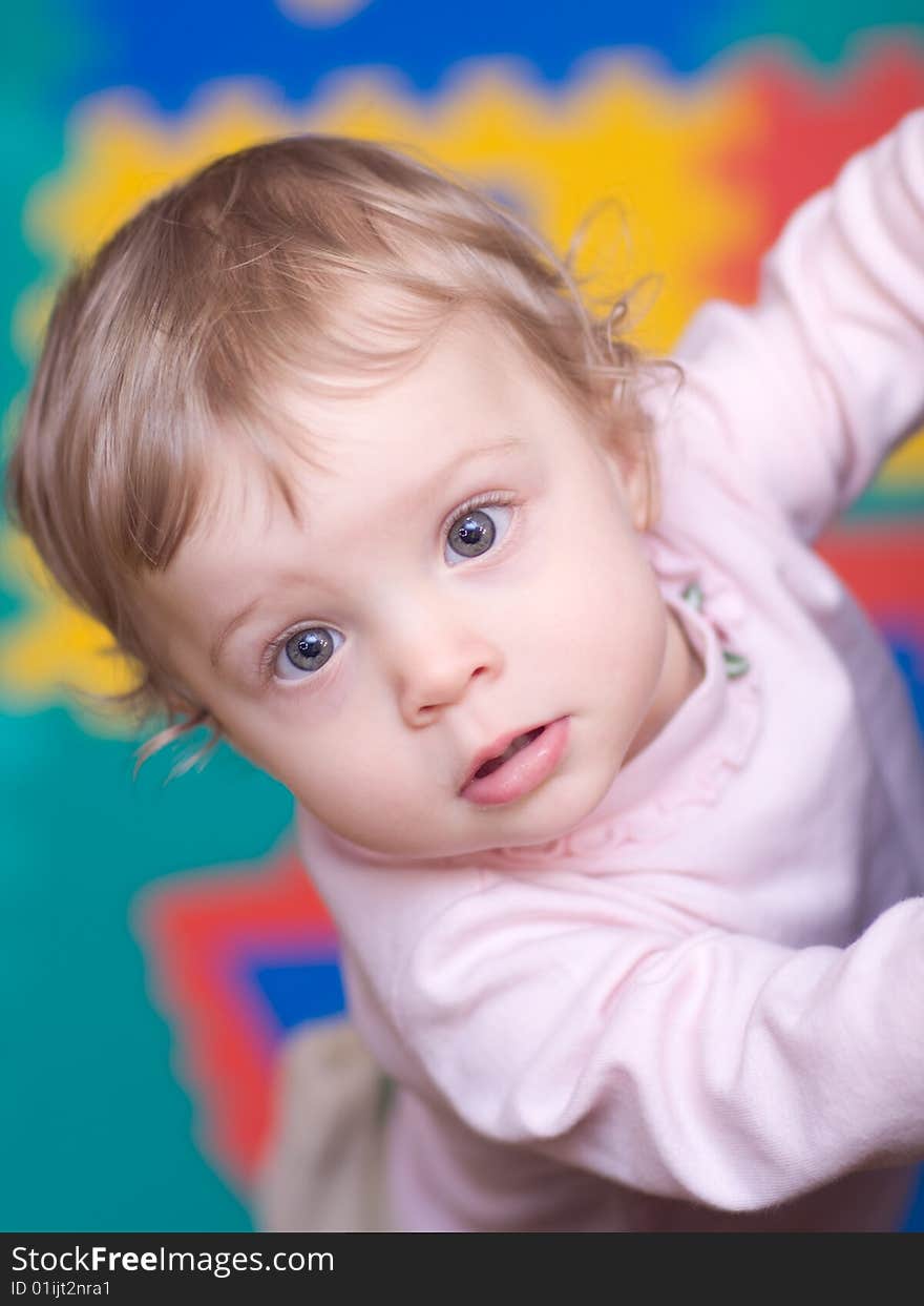 Little girl on varicolored background - shallow DOF