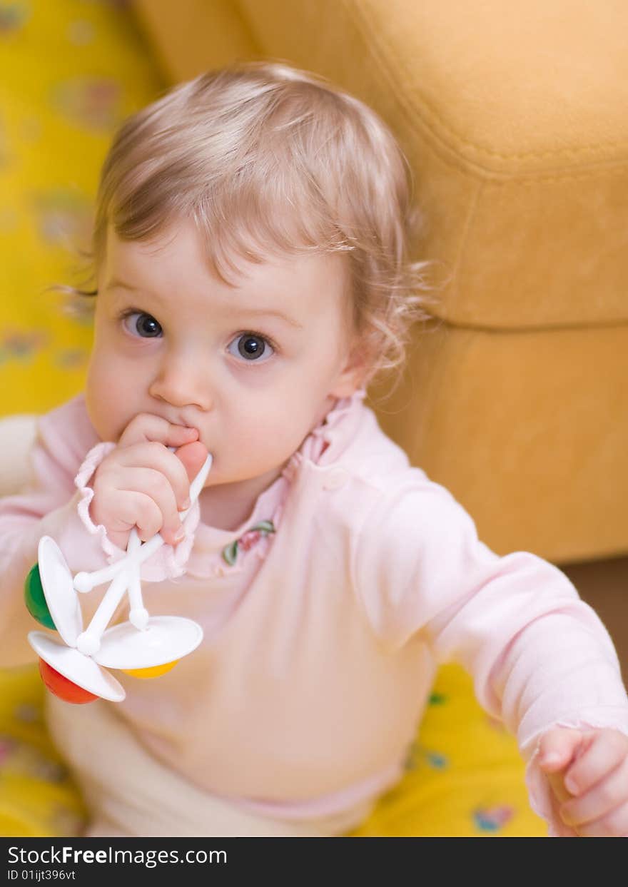 Little girl playing with rattle - shallow DOF