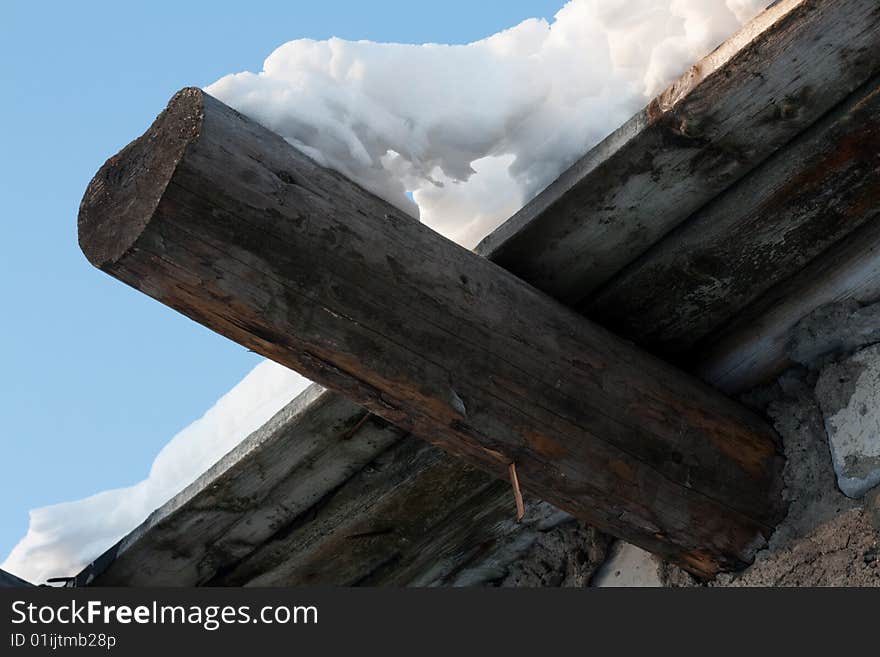 Wooden roof, drooping snow, winter, sunny, blue sky. Wooden roof, drooping snow, winter, sunny, blue sky