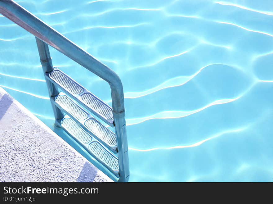 Fragment of pool with a ladder and transparent water. Fragment of pool with a ladder and transparent water