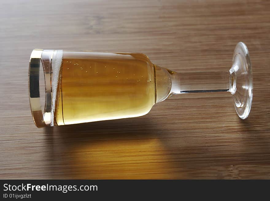 Shiny wineglass on the wood background. Shiny wineglass on the wood background