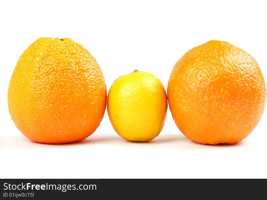 Two Orange Oranges And One Yellow Lemon