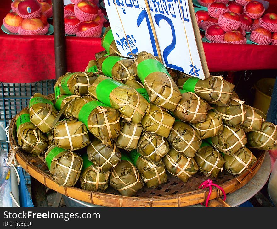 A snack wrapped in leaves, sold on Thai market. A snack wrapped in leaves, sold on Thai market