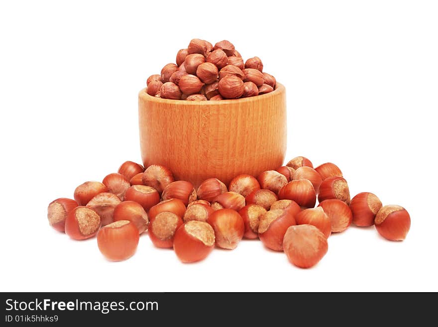 Nuts in wooden bowl isolated on white. Nuts in wooden bowl isolated on white.